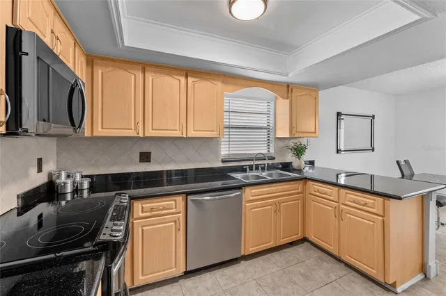 a kitchen with a sink stove and cabinets
