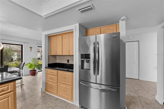 a kitchen with granite countertop a refrigerator and a sink