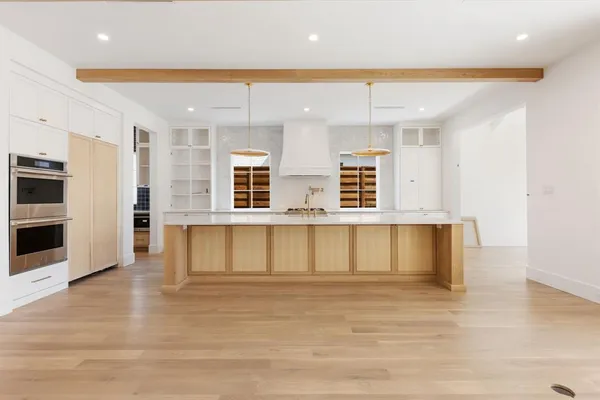 a view of kitchen with stainless steel appliances granite countertop a stove a sink and a refrigerator