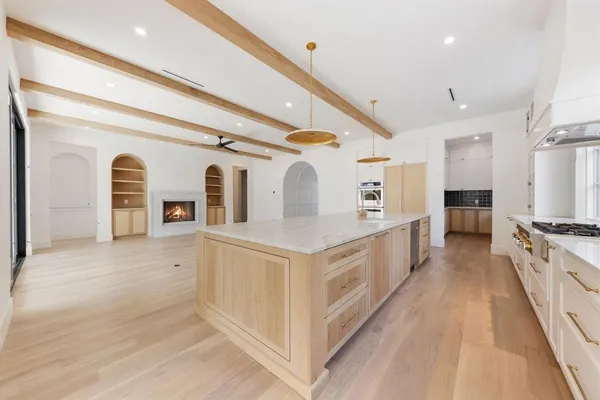 a view of kitchen with stainless steel appliances granite countertop a stove and a refrigerator