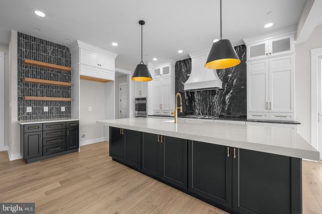 a kitchen with a sink a counter space and stainless steel appliances