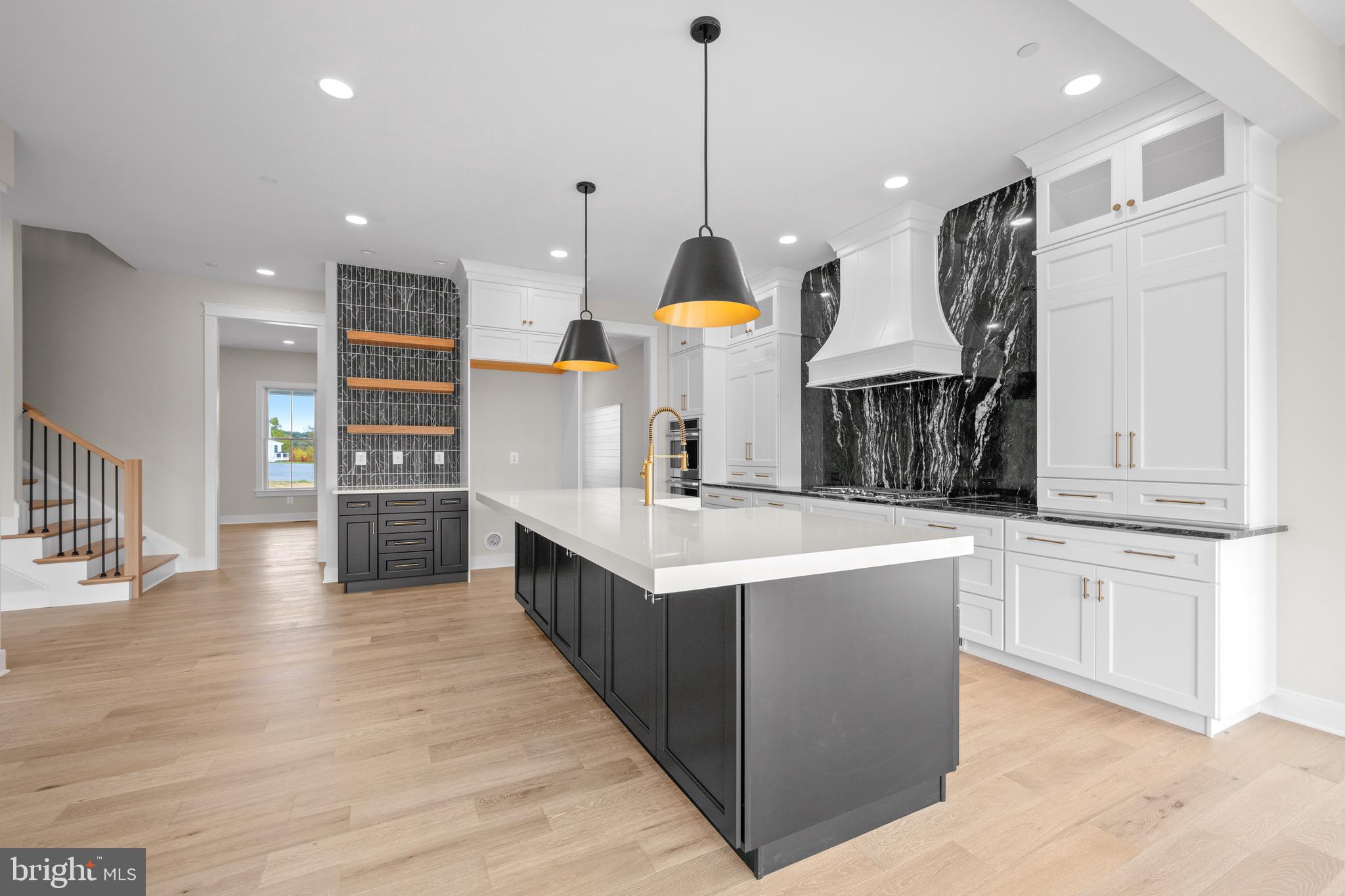 869 Morgan Station Road Woodbine, MD 21797 - Photo 15 of 38 a kitchen with stainless steel appliances granite countertop a sink a stove and a wooden floors