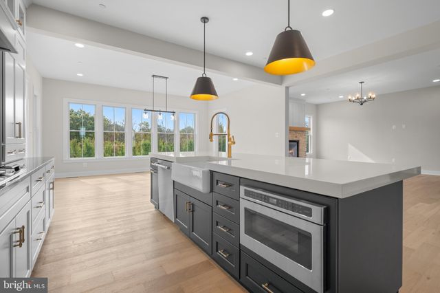 a kitchen with stainless steel appliances granite countertop a stove a sink and a wooden cabinets