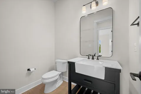 a bathroom with a sink toilet and mirror