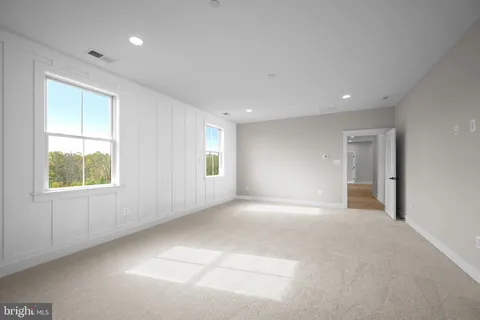 an empty room with windows and closet