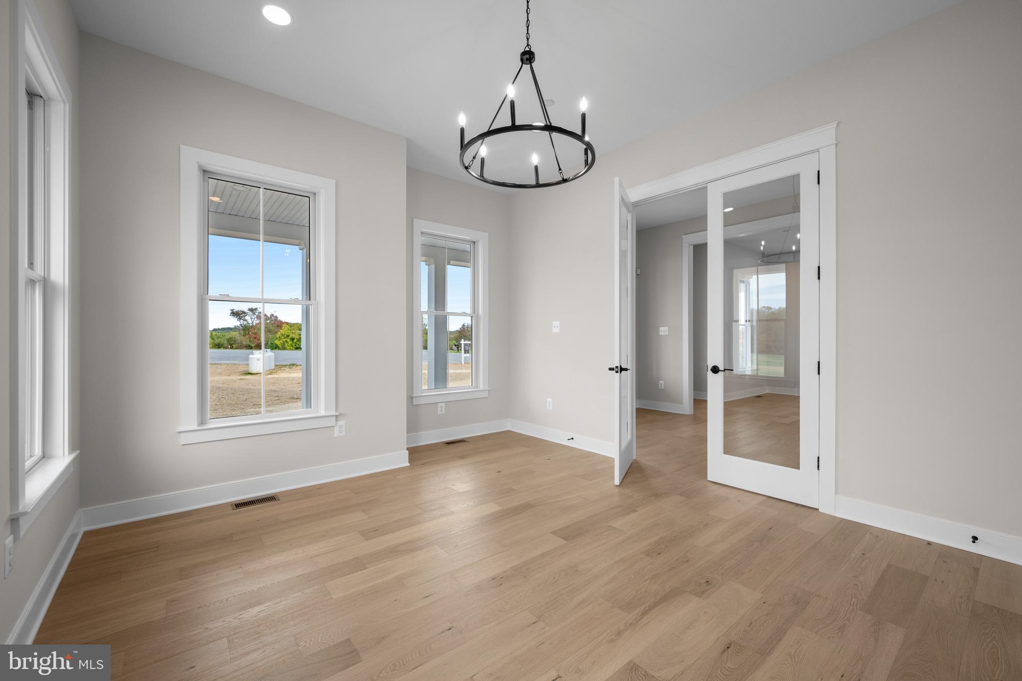 869 Morgan Station Road Woodbine, MD 21797 - Photo 7 of 38 an empty room that has a window and wooden floor