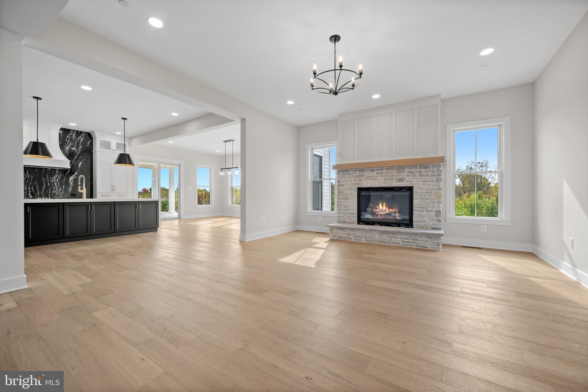 869 Morgan Station Road Woodbine, MD 21797 - Photo 9 of 38 a view of an empty room and a kitchen with fireplace wooden floor