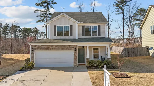 a front view of a house with a yard