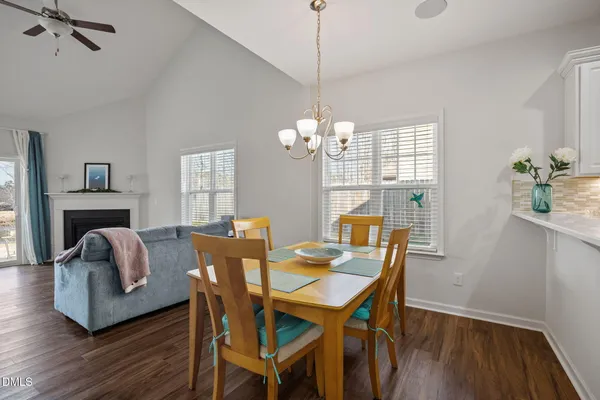 a view of a dining room with furniture wooden floor and chandelier