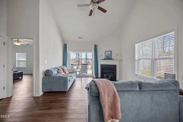 a living room with fireplace furniture and a window