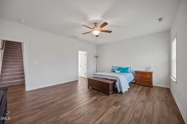 a bedroom with furniture and wooden floor