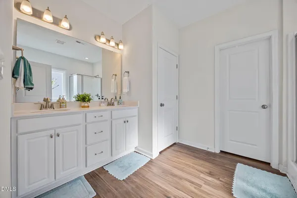 a spacious bathroom with a sink and a mirror