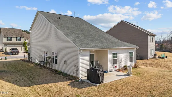 a backyard of a house with table and chairs