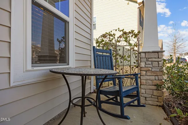 a balcony with table and chairs