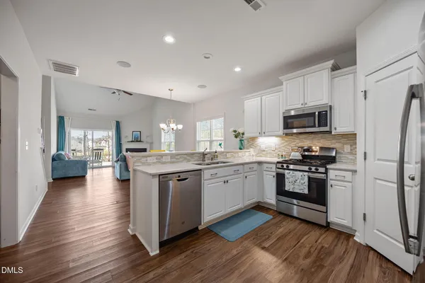 a kitchen with granite countertop stainless steel appliances and wooden cabinets