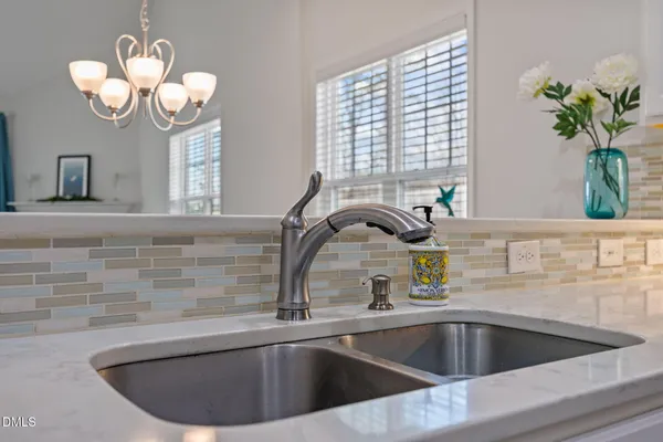 a kitchen with a sink a counter space and a window