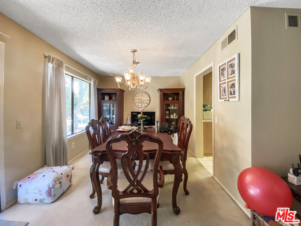 19401 Crystal Ridge Lane Porter Ranch, CA 91326 - Photo 11 of 45 a view of a dining room with furniture and chandelier