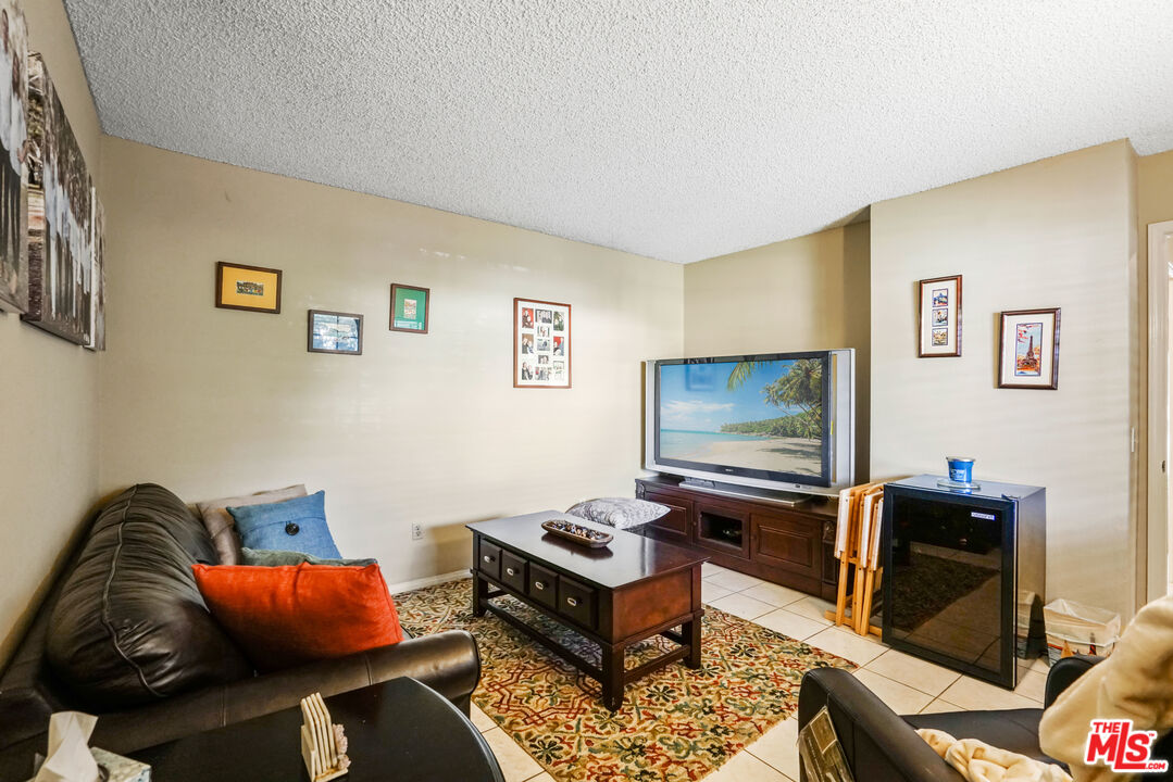 19401 Crystal Ridge Lane Porter Ranch, CA 91326 - Photo 14 of 45 a living room with furniture and a flat screen tv