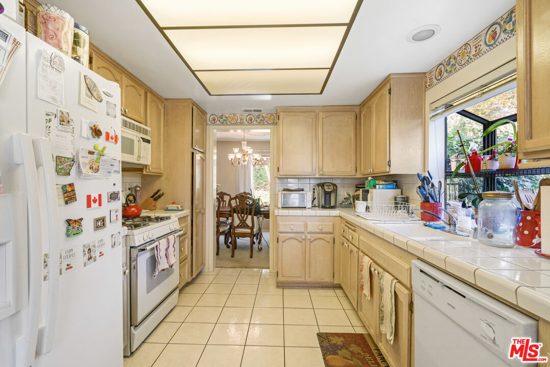19401 Crystal Ridge Lane Porter Ranch, CA 91326 - Photo 17 of 45 a kitchen with stainless steel appliances a sink and a refrigerator