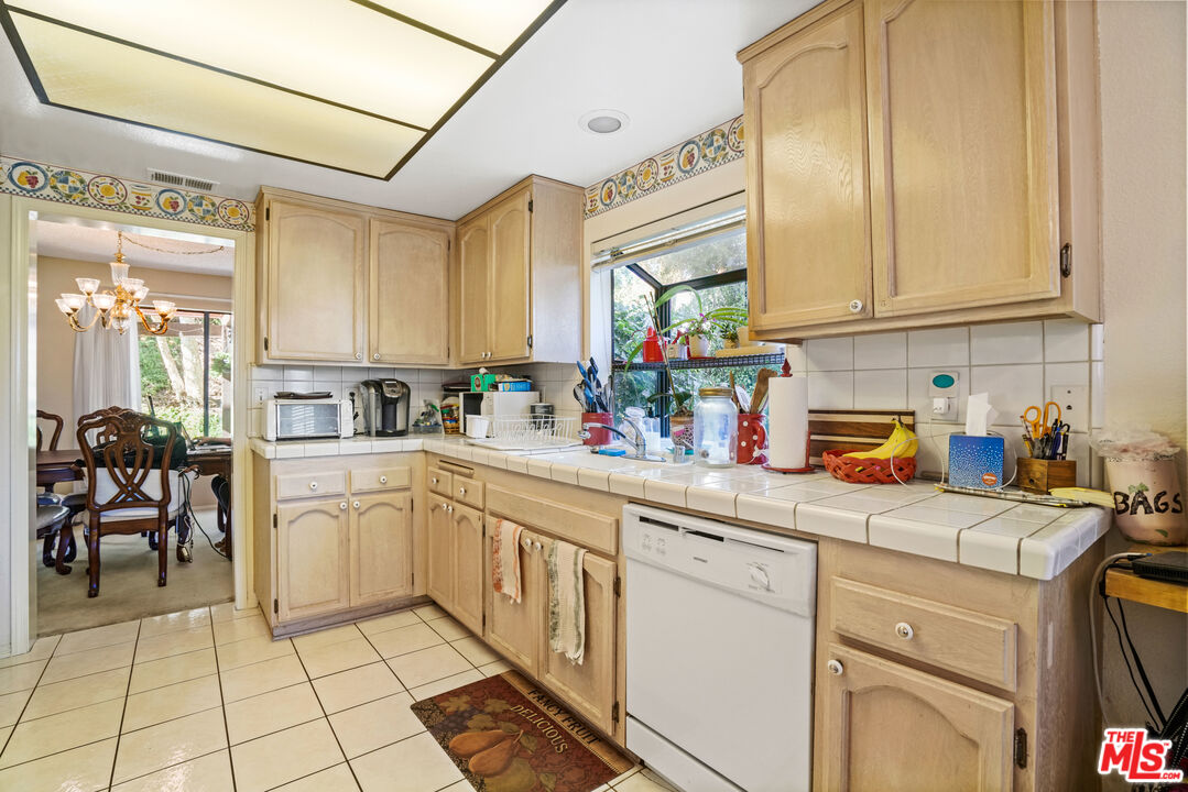 19401 Crystal Ridge Lane Porter Ranch, CA 91326 - Photo 20 of 45 a kitchen with stainless steel appliances granite countertop a sink and cabinets