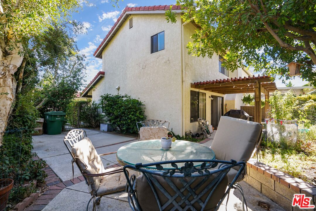 19401 Crystal Ridge Lane Porter Ranch, CA 91326 - Photo 21 of 45 a view of a patio with table and chairs and potted plants