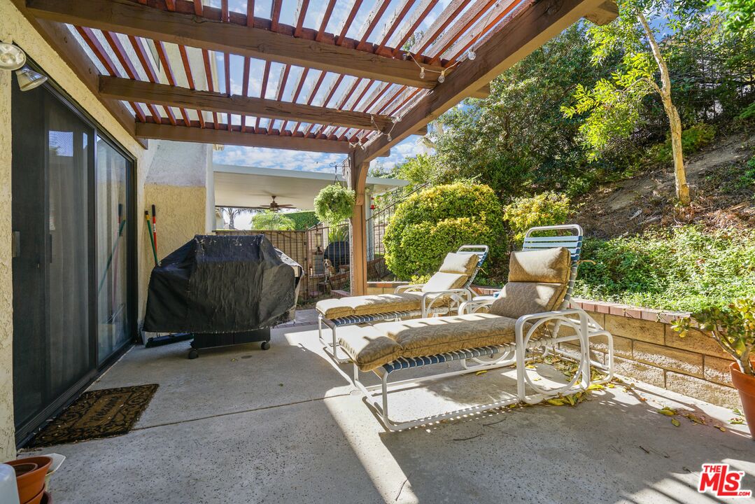 19401 Crystal Ridge Lane Porter Ranch, CA 91326 - Photo 23 of 45 a view of a porch with furniture and a yard