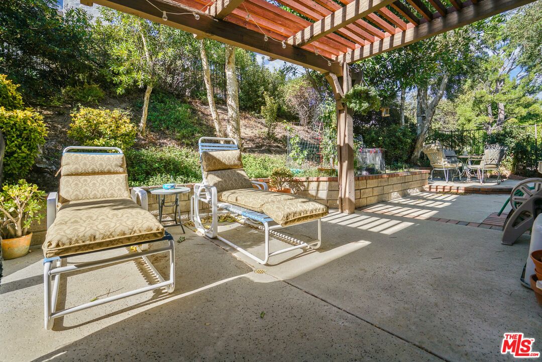 19401 Crystal Ridge Lane Porter Ranch, CA 91326 - Photo 24 of 45 a view of a patio with table and chairs and potted plants