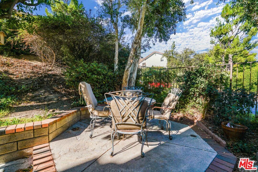 19401 Crystal Ridge Lane Porter Ranch, CA 91326 - Photo 26 of 45 a view of a chair and tables in the patio