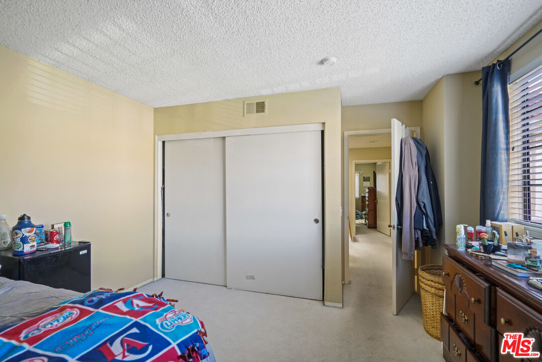 19401 Crystal Ridge Lane Porter Ranch, CA 91326 - Photo 30 of 45 a bedroom with a bed and a dresser in it