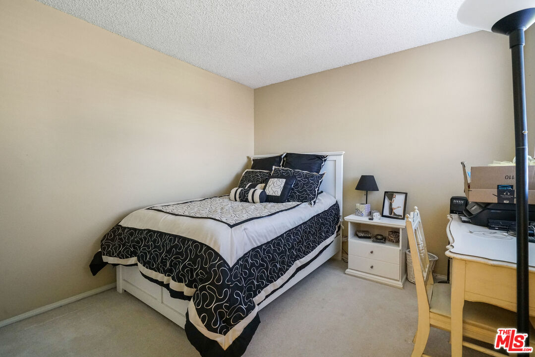19401 Crystal Ridge Lane Porter Ranch, CA 91326 - Photo 32 of 45 a bedroom with a bed and dresser