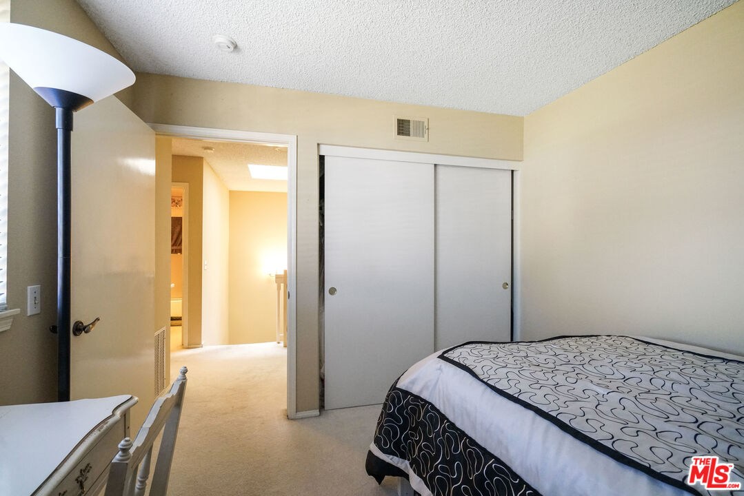 19401 Crystal Ridge Lane Porter Ranch, CA 91326 - Photo 33 of 45 a bedroom with a bed and a chandelier