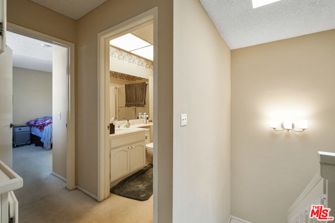 19401 Crystal Ridge Lane Porter Ranch, CA 91326 - Photo 34 of 45 a en suite bathroom with a sink and a mirror