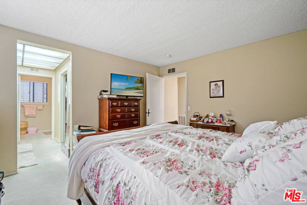 19401 Crystal Ridge Lane Porter Ranch, CA 91326 - Photo 35 of 45 a bedroom with a large bed and a dresser