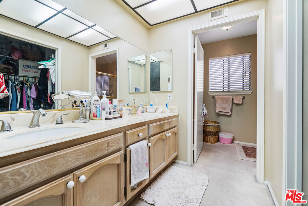 19401 Crystal Ridge Lane Porter Ranch, CA 91326 - Photo 36 of 45 a bathroom with a sink and a mirror