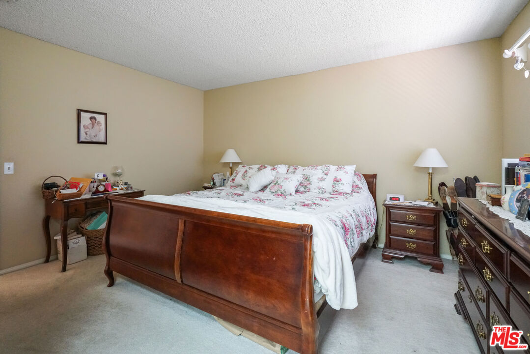 19401 Crystal Ridge Lane Porter Ranch, CA 91326 - Photo 39 of 45 a bedroom with a bed and a dresser in it