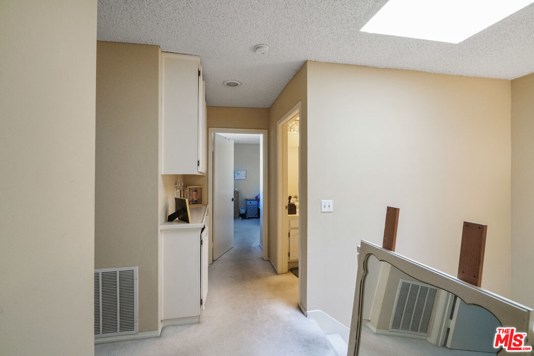 19401 Crystal Ridge Lane Porter Ranch, CA 91326 - Photo 40 of 45 a view of hallway with bathroom and wooden floor