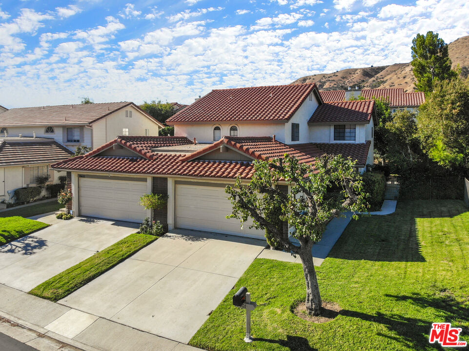 19401 Crystal Ridge Lane Porter Ranch, CA 91326 - Photo 5 of 45 a front view of a house with garden