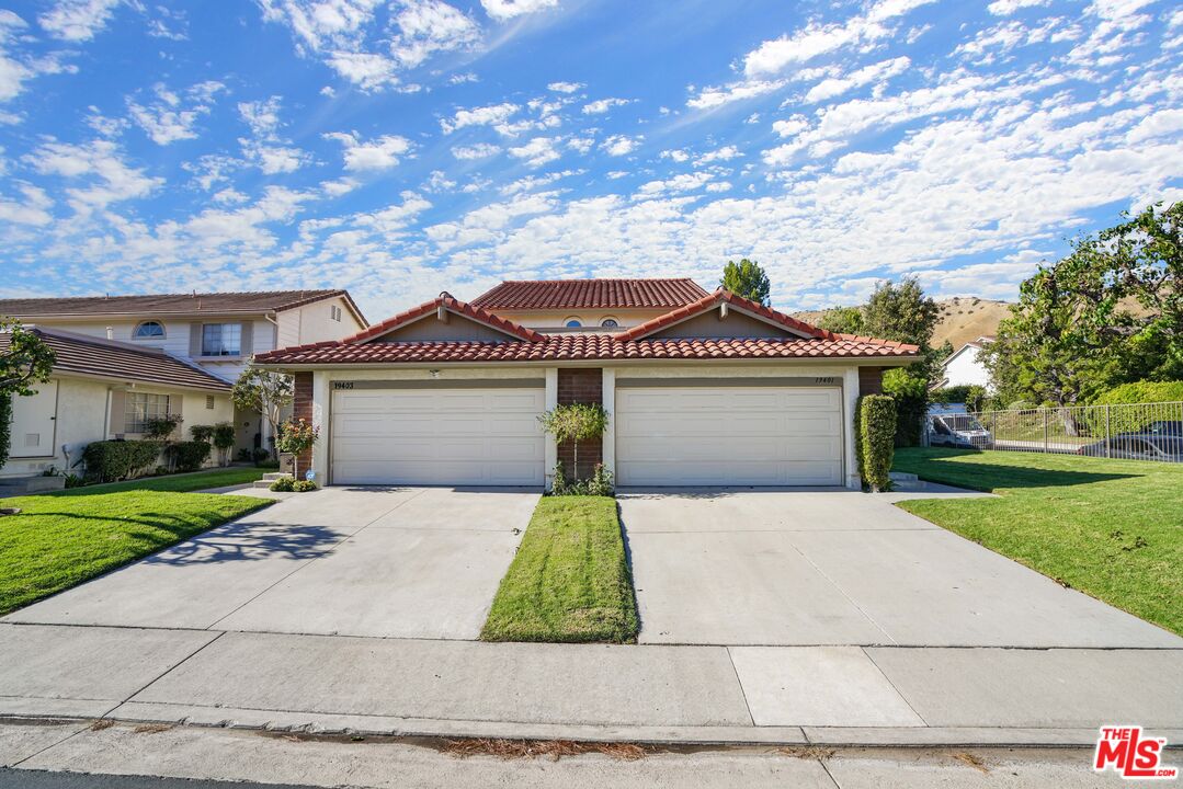 19401 Crystal Ridge Lane Porter Ranch, CA 91326 - Photo 45 of 45 a front view of a house with a yard and garage