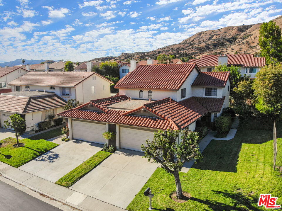 19401 Crystal Ridge Lane Porter Ranch, CA 91326 - Photo 6 of 45 a view of a house with a yard and plants