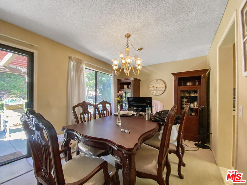 19401 Crystal Ridge Lane Porter Ranch, CA 91326 - Photo 9 of 45 a view of a dining room with furniture and a chandelier