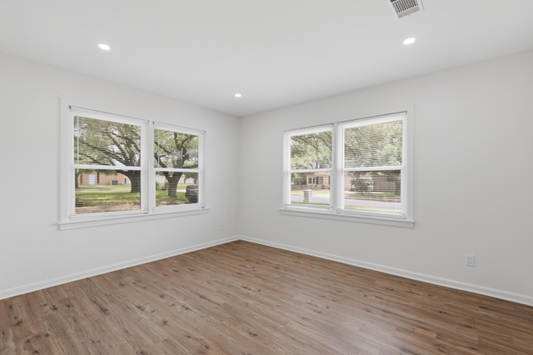 1608 Burt Street Bryan, TX 77802 - Photo 6 of 16 an empty room with wooden floor and windows