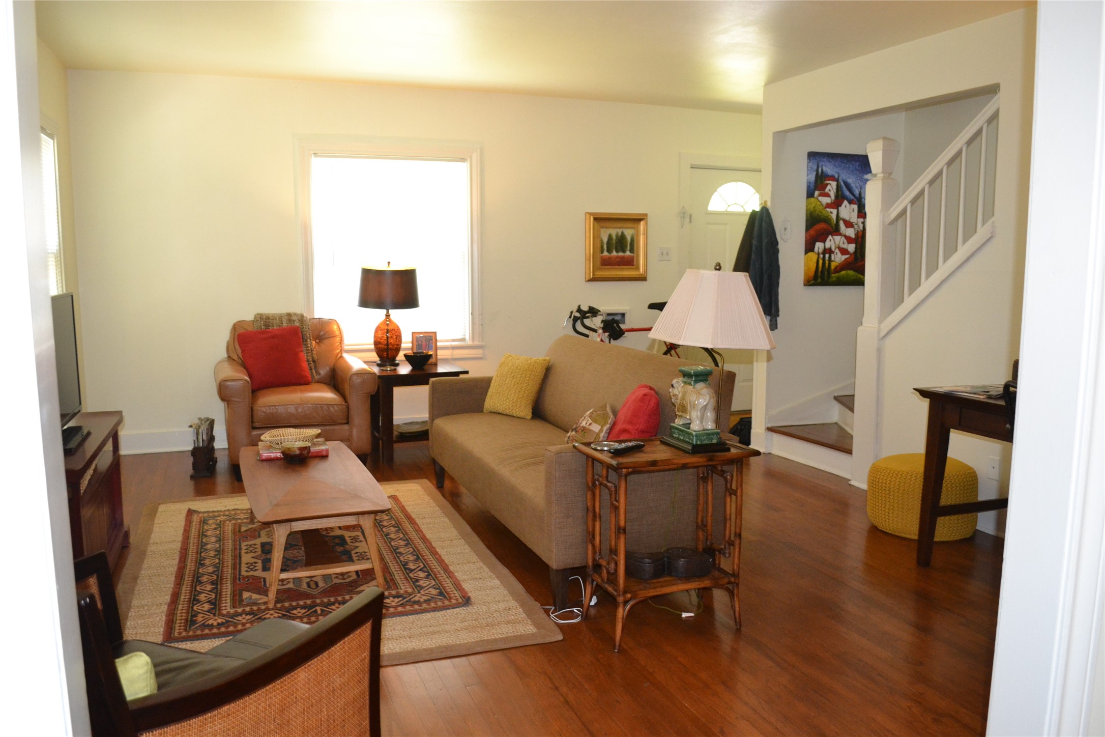 a living room with furniture and wooden floor
