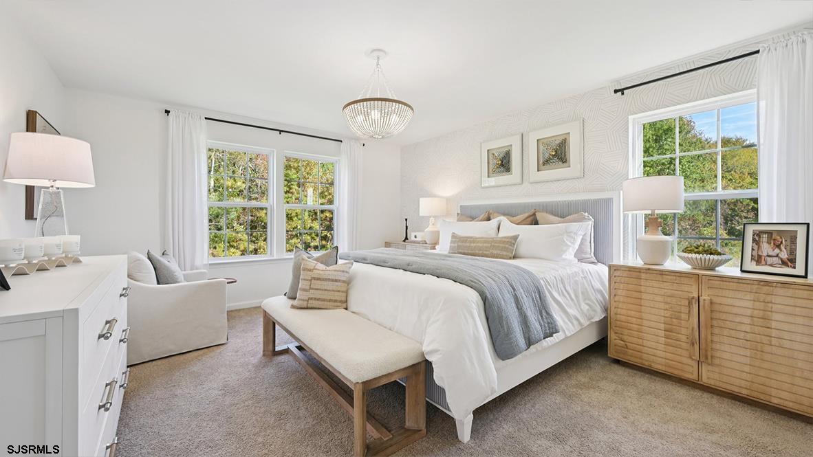 505 Scotty Boulevard, Unit 1302 Rio Grande, NJ 08242 - Photo 39 of 41 a spacious bedroom with a bed and a large window