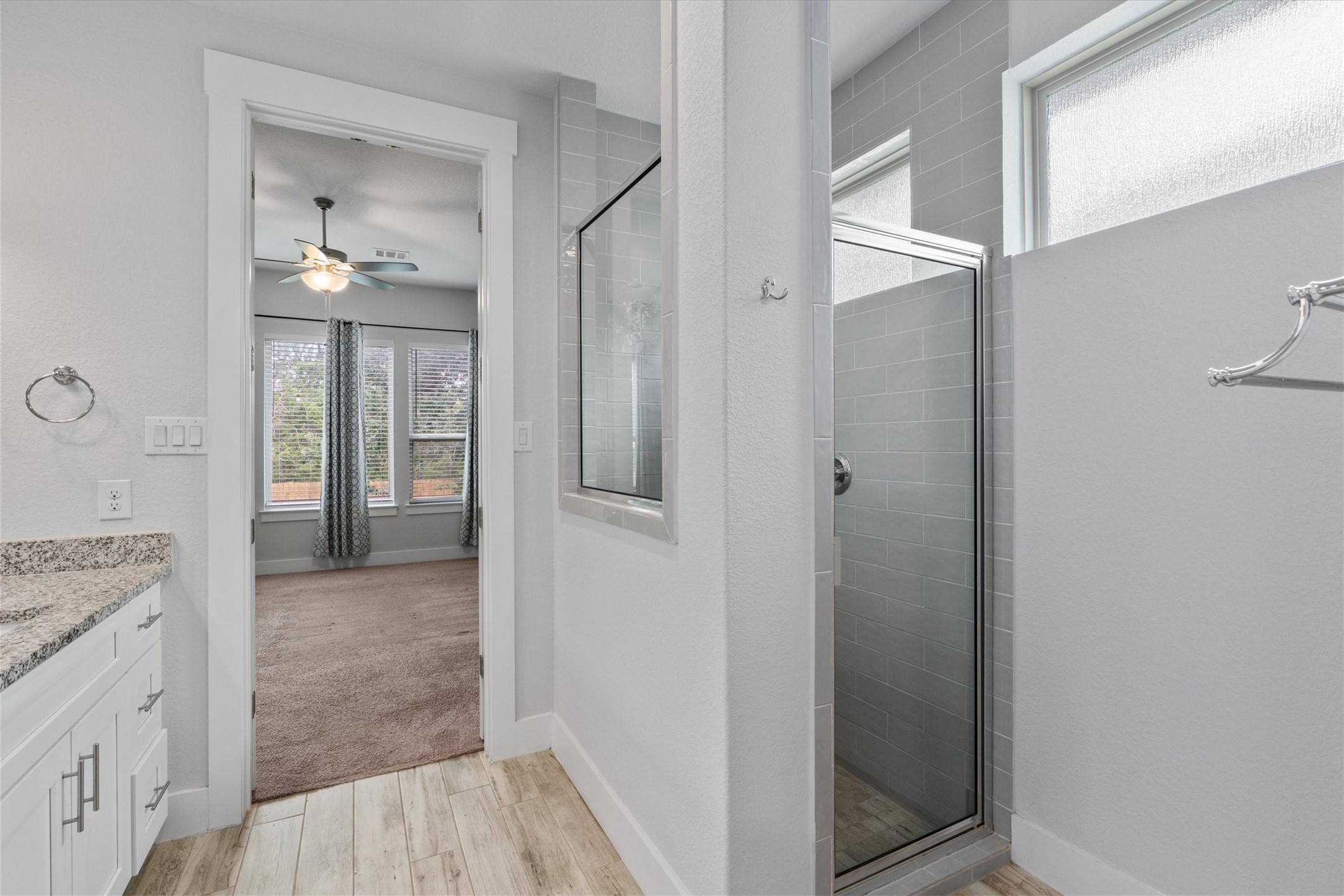 941 Del Raphael Drive Leander, TX 78641 - Photo 14 of 31 The walk-in shower features upgraded tile work, giving the whole room a clean, refreshed aesthetic