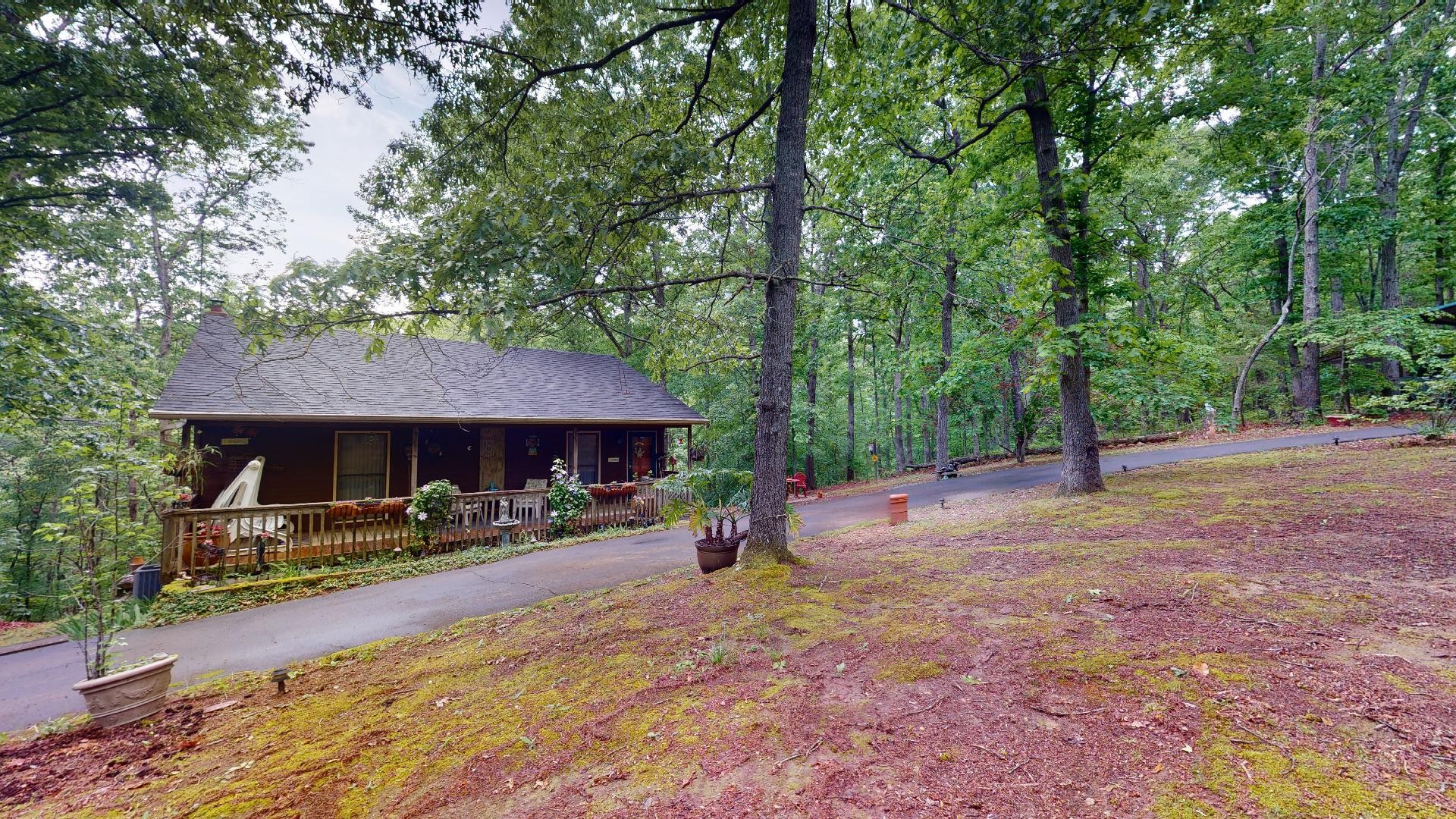 6616 Wesley Ridge Road Lyles, TN 37098 - Photo 3 of 28 a backyard of a house with barbeque oven table and chairs