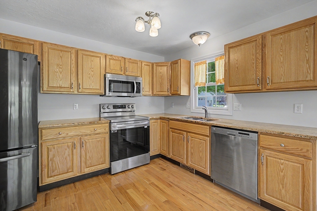 792 Ryan Road Northampton, MA 01062 - Photo 7 of 29 a kitchen with granite countertop a sink stainless steel appliances and cabinets