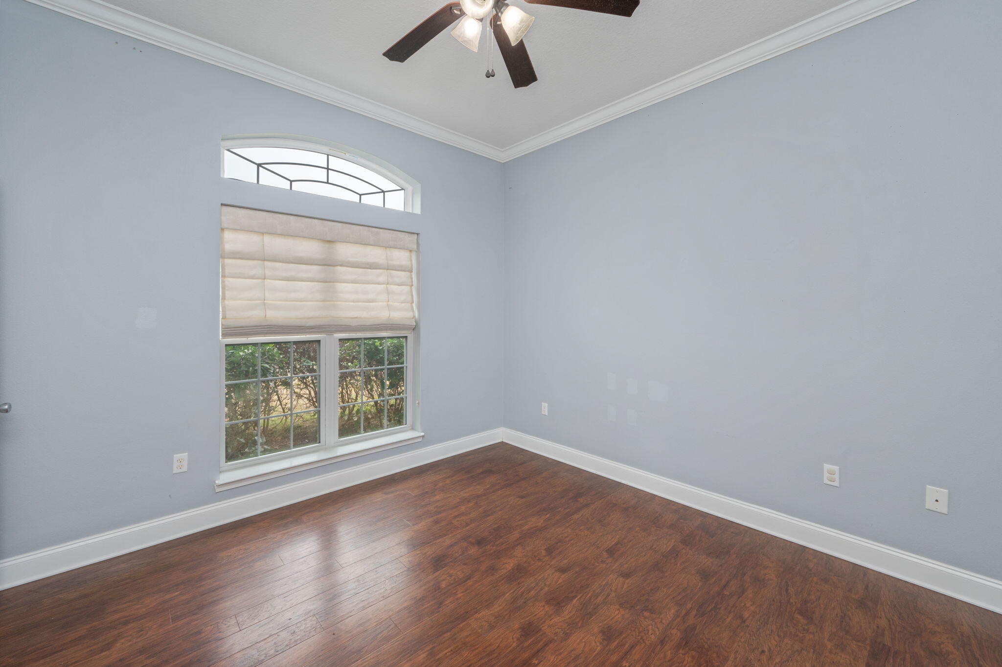 2909 Chancery Lane Crestview, FL 32539 - Photo 11 of 34 a view of an empty room with wooden floor and a window