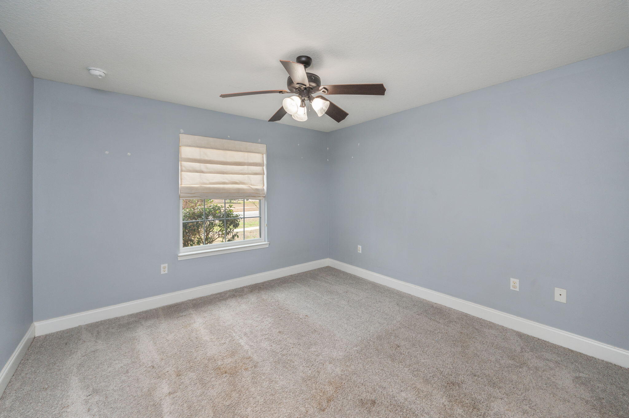 2909 Chancery Lane Crestview, FL 32539 - Photo 22 of 34 an empty room with windows and fan