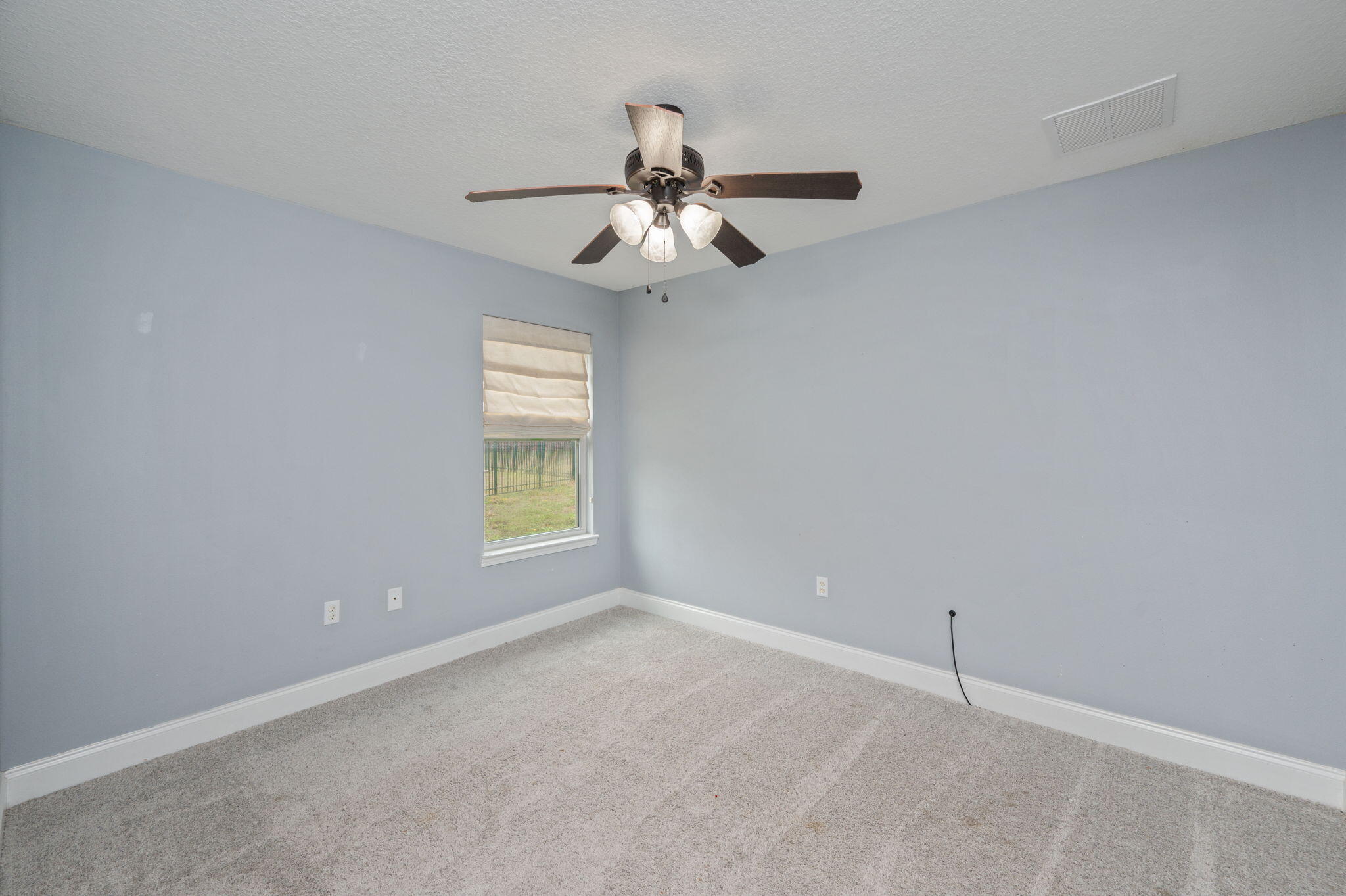 2909 Chancery Lane Crestview, FL 32539 - Photo 24 of 34 an empty room with windows and fan