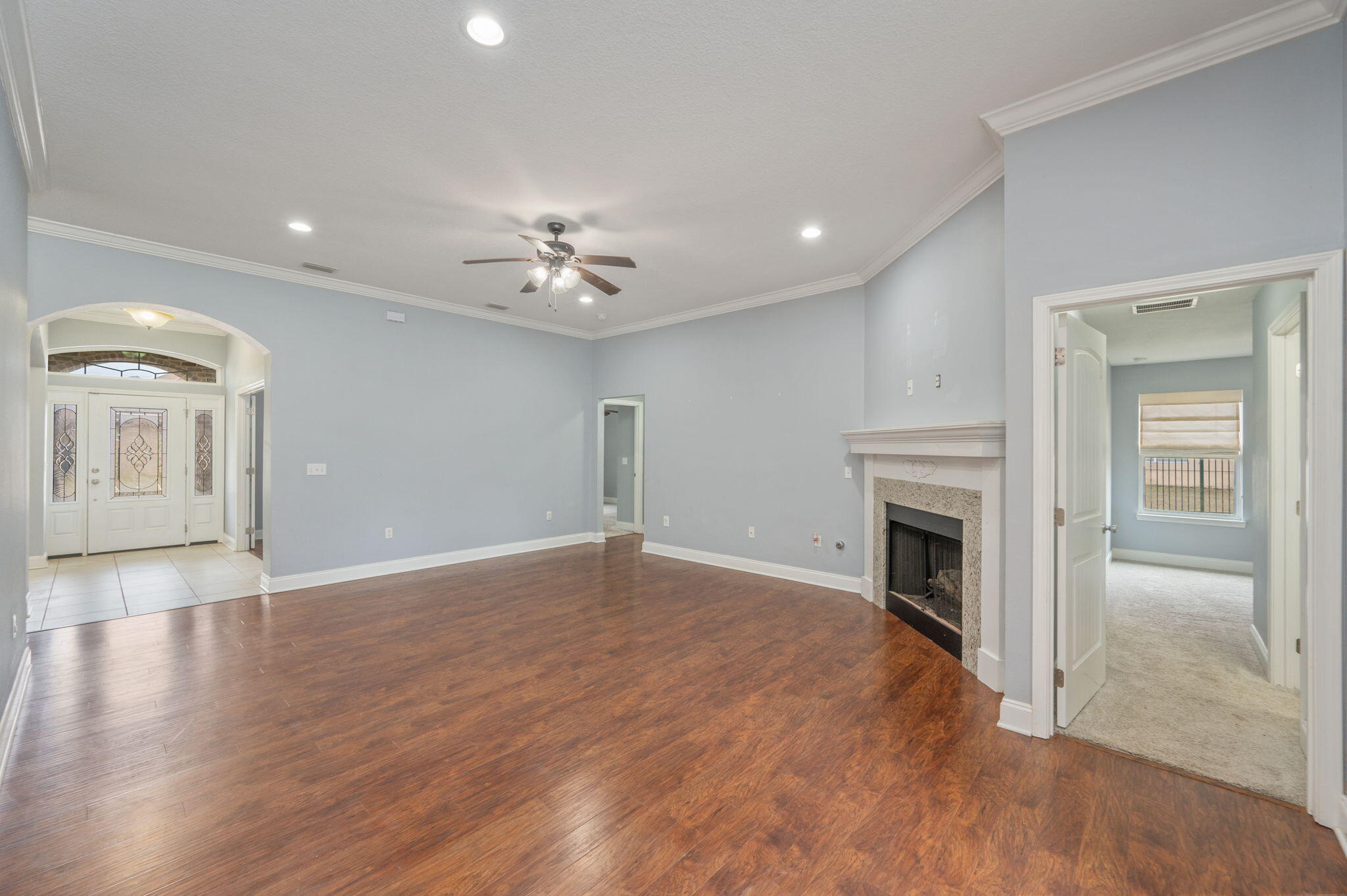 2909 Chancery Lane Crestview, FL 32539 - Photo 5 of 34 a view of an empty room with wooden floor and a fireplace